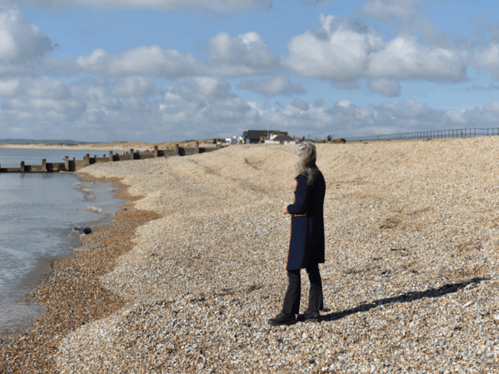 Lady looking out to see at Camber Sands, East Sussex promoting Grief and Loss Coaching