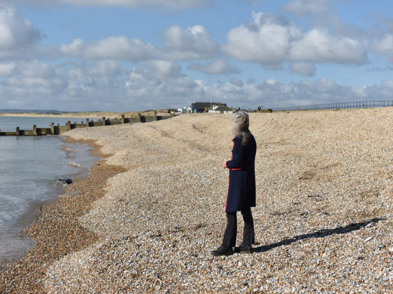 Lady looking out to see at Camber Sands, East Sussex promoting Grief and Loss Coaching